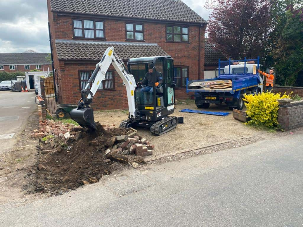 This is a photo of an operative of NS Driveways Ashtead Digging out for a new tarmac driveway